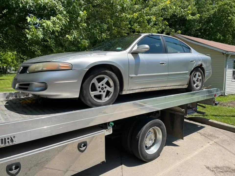 Rusted silver Pontiac Grand Prix showing typical wear on a vehicle ready to sell for cash